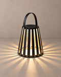 Solsence Ember portable solar lantern lit with warm 3000K glow on a greige wall