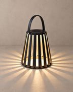 Solsence Ember portable solar lantern lit with warm 3000K glow on a greige wall