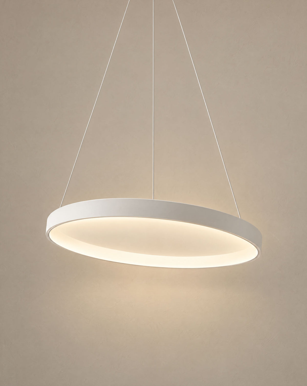 Solsence Halo white round LED ring pendant light lit with warm 3000K glow in front of a greige wall