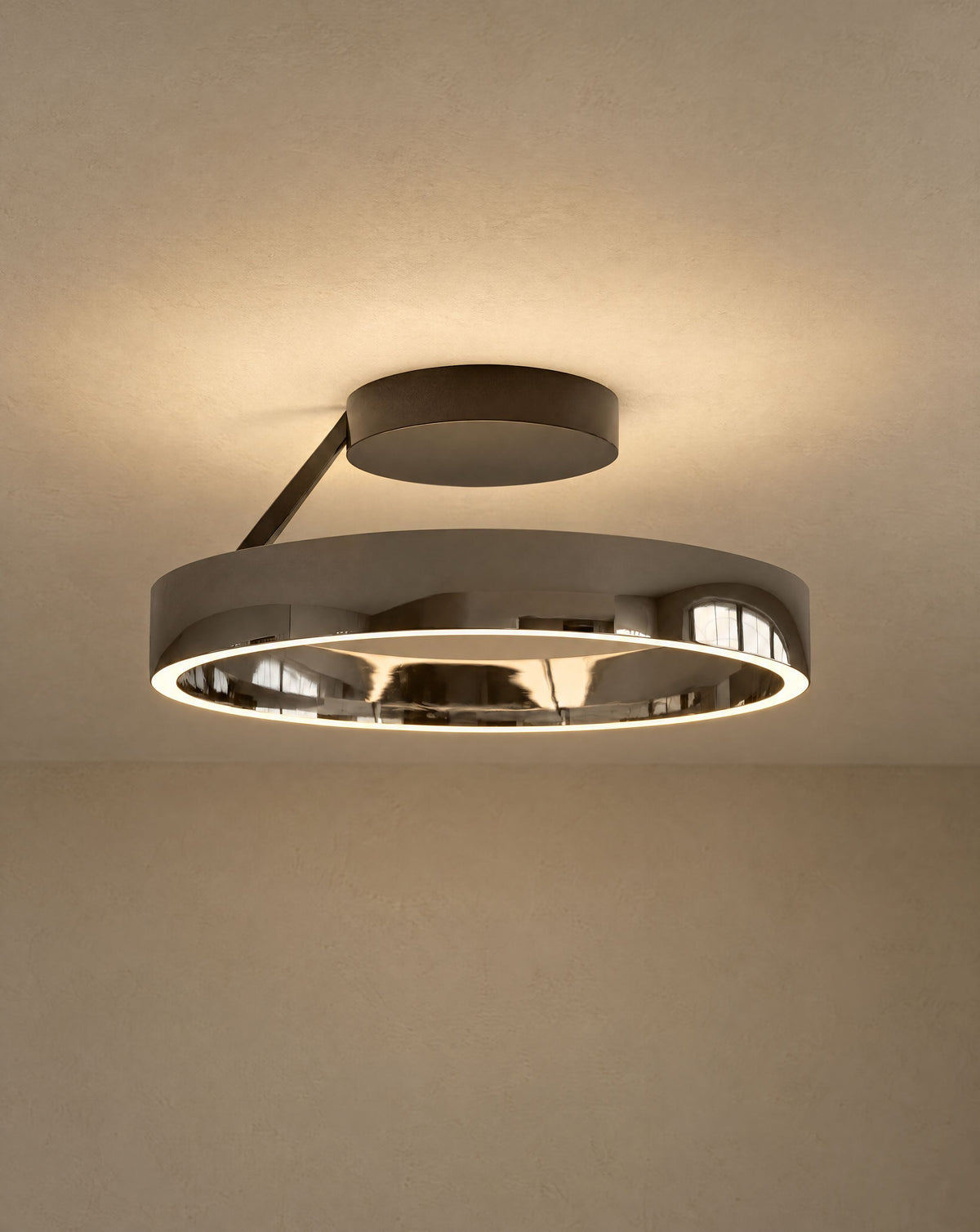 Solsence Solis ring ceiling light - Black Chrome lit with warm 3000K glow on a greige wall