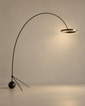 Solsence Aurelia arc floor lamp - Black Chrome lit with warm 3000K glow on a greige wall