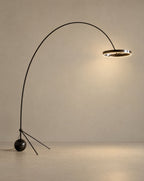 Solsence Aurelia arc floor lamp - Black Chrome lit with warm 3000K glow on a greige wall