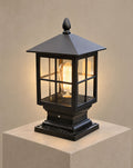 SCI Lighting Aldwin traditional pillar light lit with warm 3000K glow on a greige wall