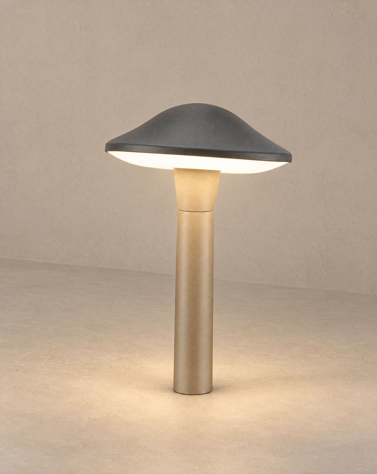 Solsence Morel mushroom path light lit with warm 3000K glow on a greige wall