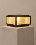 SCI Lighting Pharos black square LED pillar light on a greige pillar with warm 3000K glow