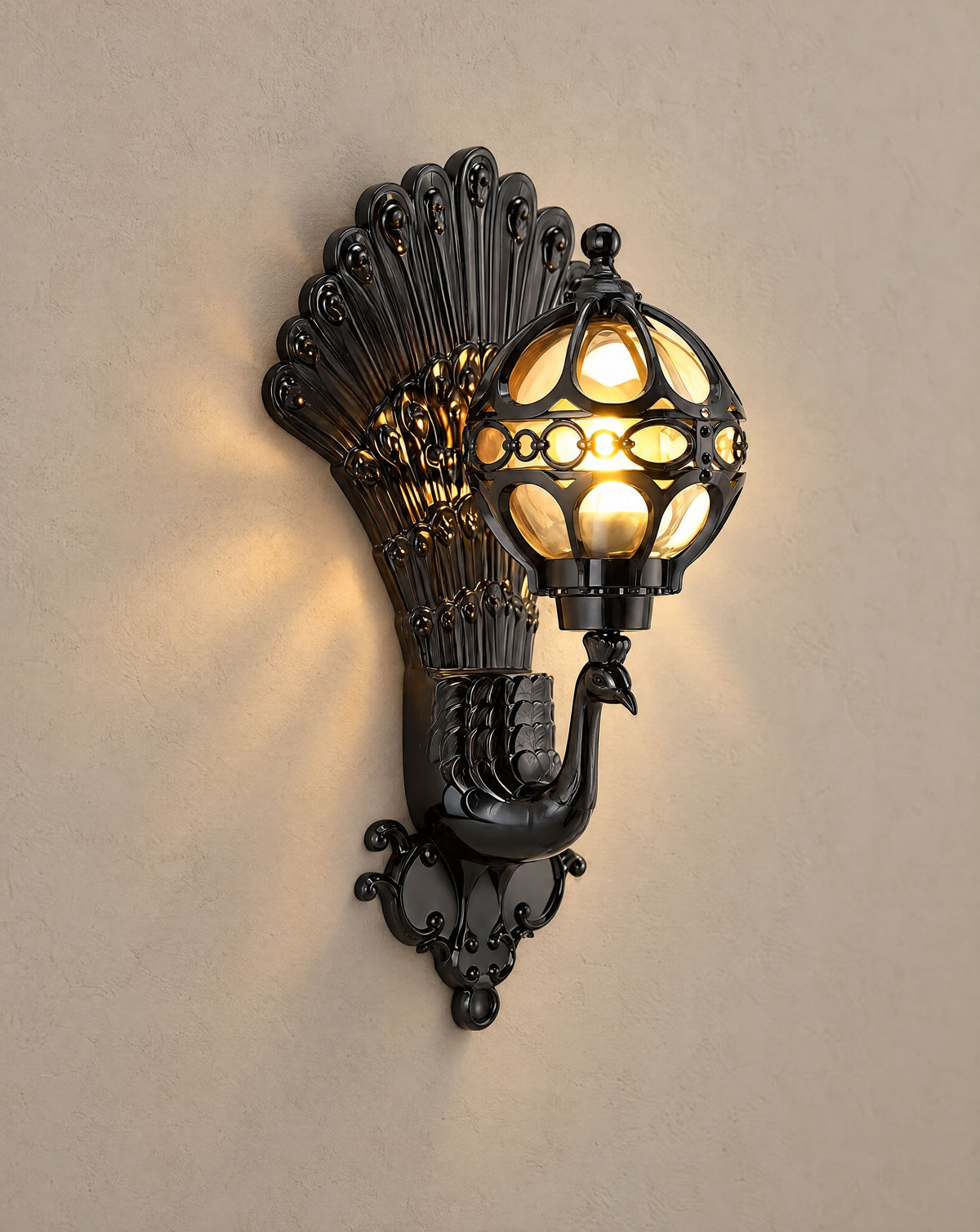 Solsence Pavo black peacock wall sconce lit with warm 3000K glow on a greige wall