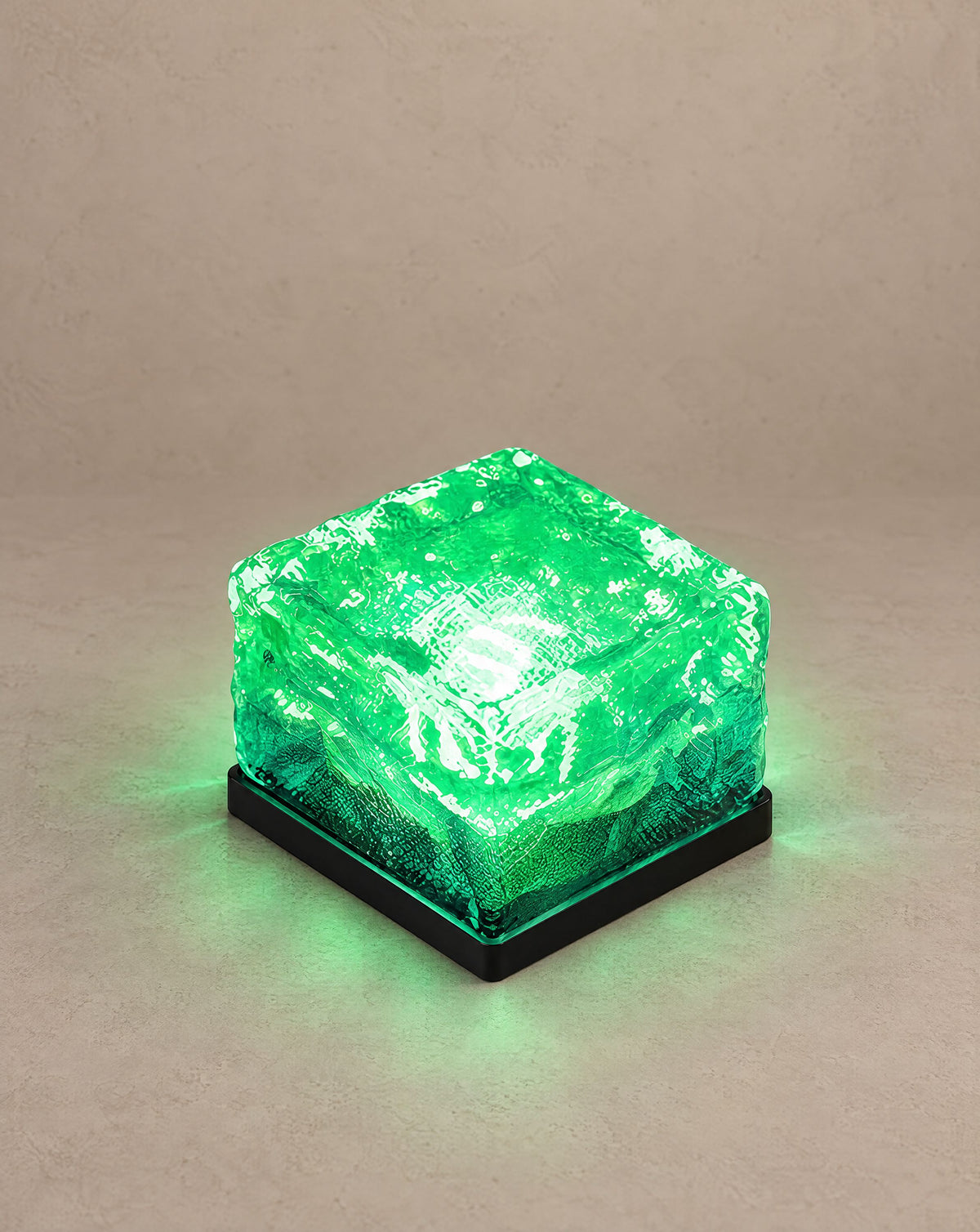 Solsence Glacier solar ice cube step light with green glow on a greige backdrop