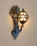SCI Lighting Pavo colorful peacock wall sconce lit with warm 3000K glow on a greige wall