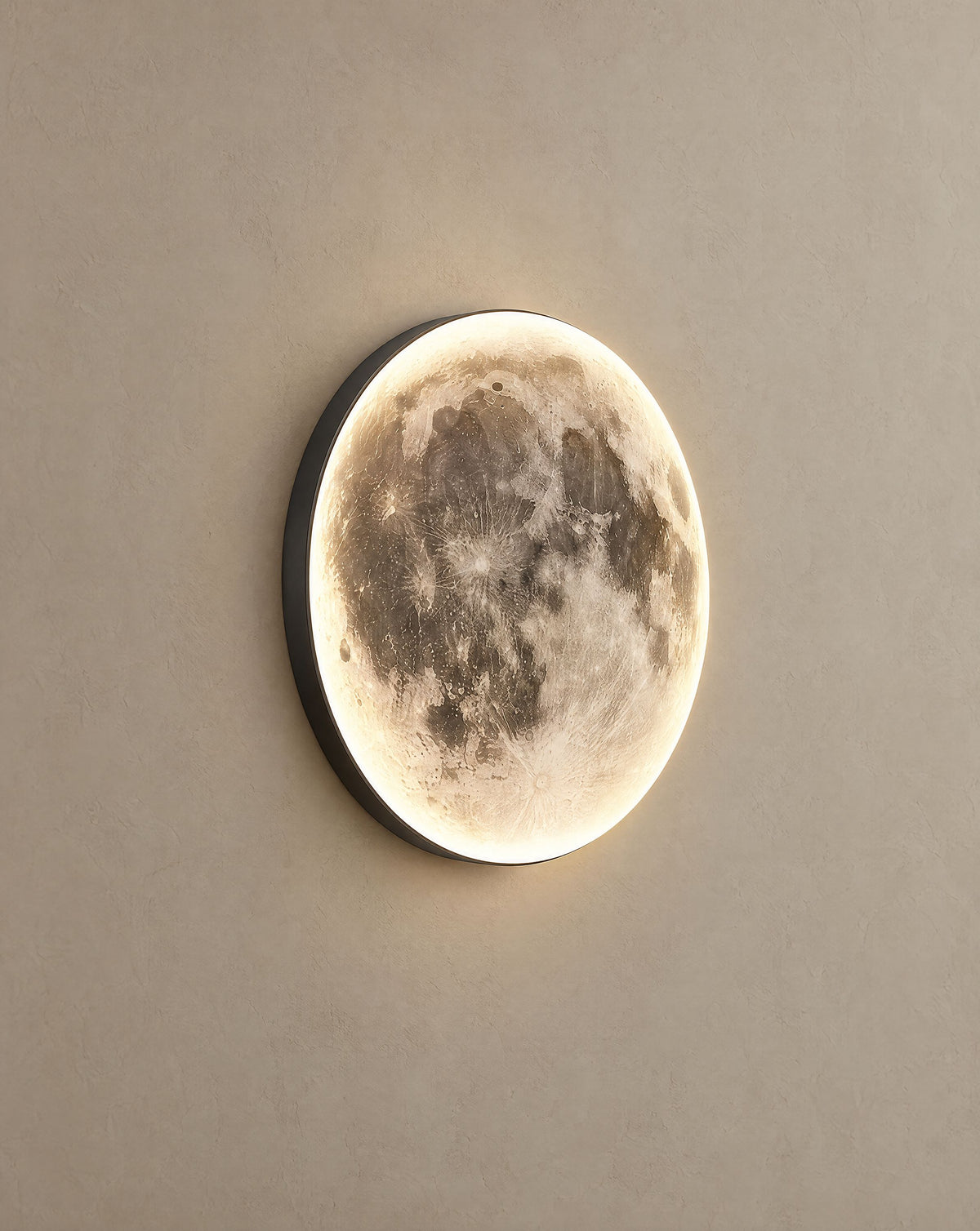 Solsence Orbis moon wall light lit with warm 3000K glow on a greige wall