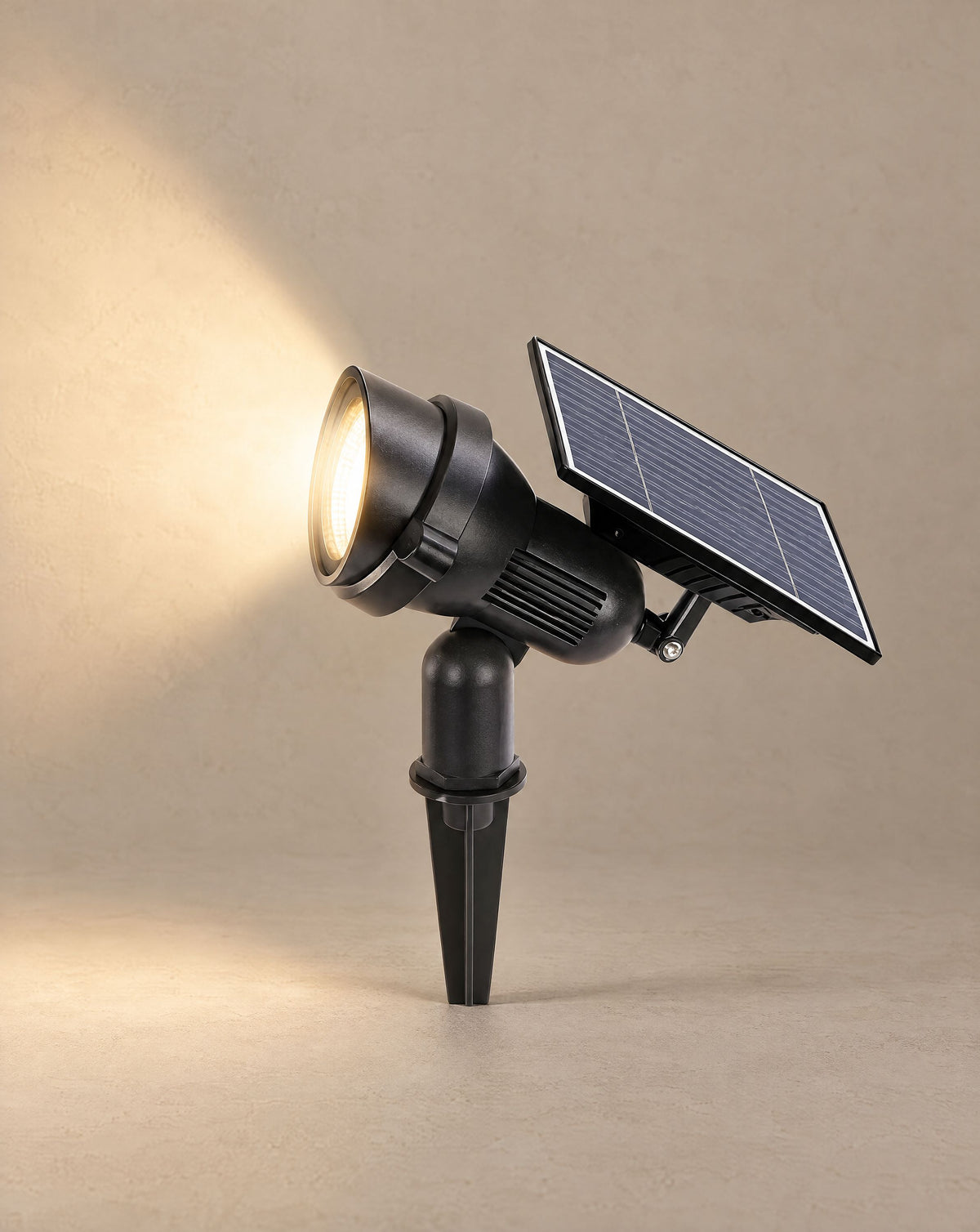 Solsence Beacon solar spotlight lit with warm 3000K glow against a greige backdrop
