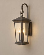 SCI Lighting Harlow outdoor wall lantern lit with warm 3000K glow on a greige wall