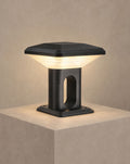 SCI Lighting Ridge hardwired gate pillar light lit with warm 3000K glow on a greige wall