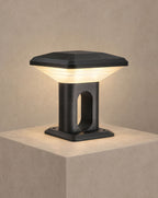 SCI Lighting Ridge hardwired gate pillar light lit with warm 3000K glow on a greige wall