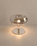 SCI Lighting Fungo mushroom table lamp - Chrome lit with warm 3000K glow on a greige wall