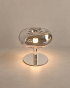 SCI Lighting Fungo mushroom table lamp - Chrome lit with warm 3000K glow on a greige wall