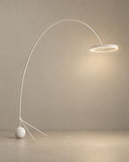 Solsence Aurelia arc floor lamp - White lit with warm 3000K glow on a greige wall