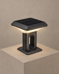 SCI Lighting Ridge solar gate pillar light lit with warm 3000K glow on a greige wall