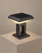 SCI Lighting Ridge solar gate pillar light lit with warm 3000K glow on a greige wall
