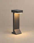 SCI Lighting Tessel hardwired path light lit with warm 3000K glow against a greige backdrop