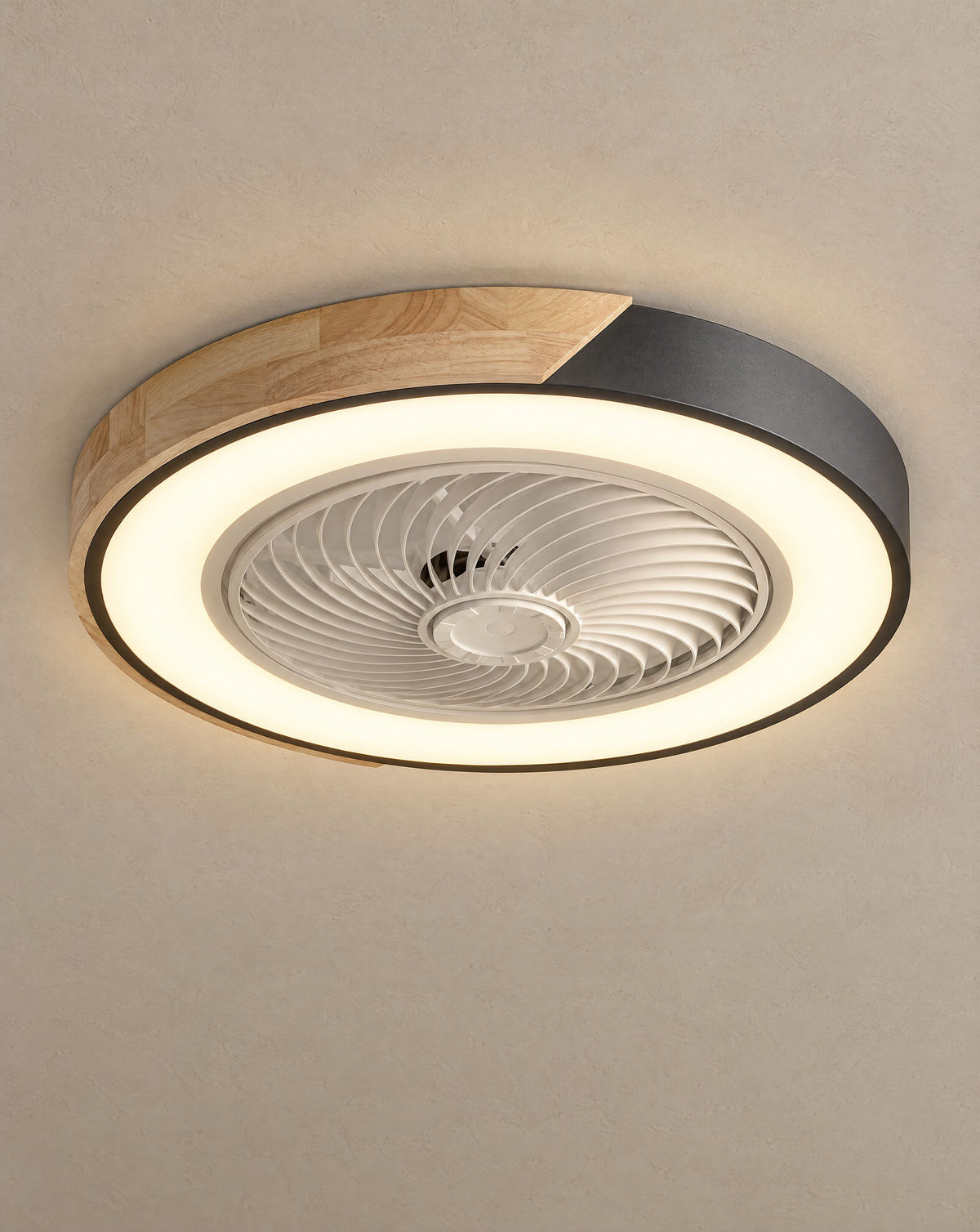 Solsence Aeris black round bladeless ceiling fan with light lit with warm 3000K glow against a greige backdrop