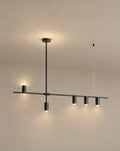 SCI Lighting Cylo black cylinder ceiling light lit with warm 3000K glow against a greige backdrop