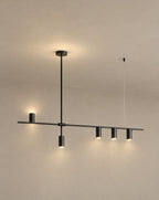 SCI Lighting Cylo black cylinder ceiling light lit with warm 3000K glow against a greige backdrop