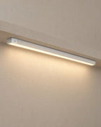 Solsence Vela wireless motion sensor light bar - Silver lit with warm 3000K glow under a greige microcement shelf