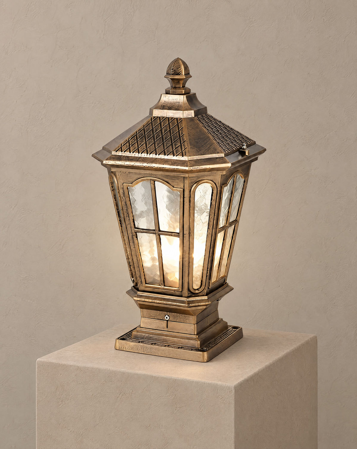 Solsence Pagoda bronze hardwired pillar light lit with warm 3000K glow on a greige wall