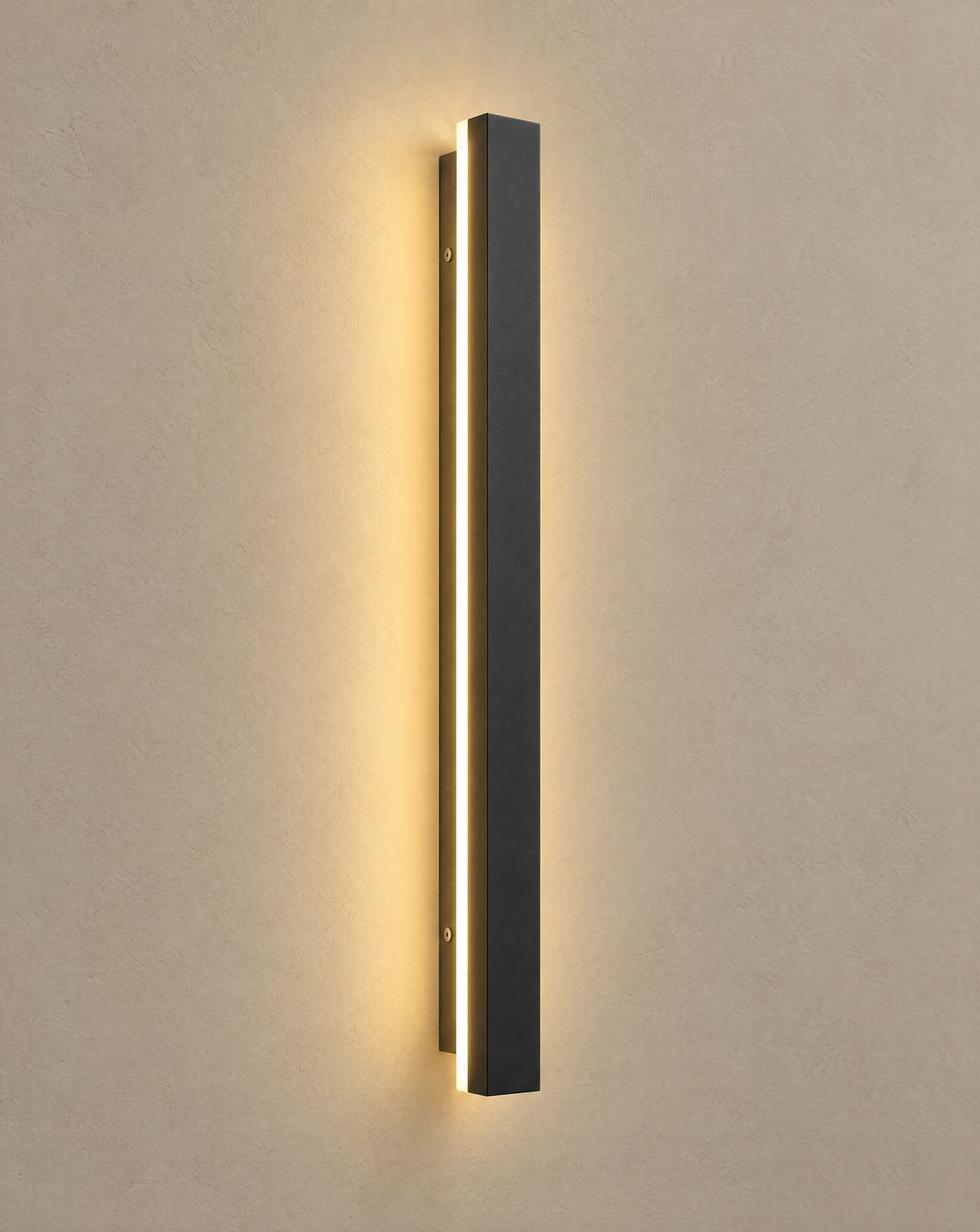 Solsence Linea slim black LED linear outdoor wall light lit with warm 3000K glow on a greige wall