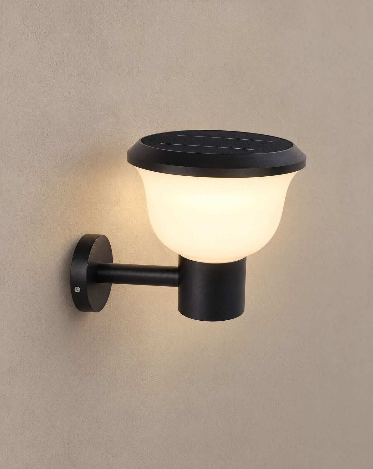 Solsence Chalice solar cup outdoor wall light lit with warm 3000K glow on a greige wall