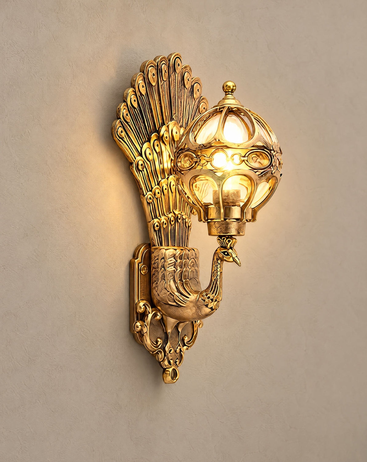 Solsence Pavo bronze peacock wall sconce lit with warm 3000K glow on a greige wall