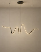 Solsence Lyra linear pendant light lit with warm 3000K glow on a greige wall