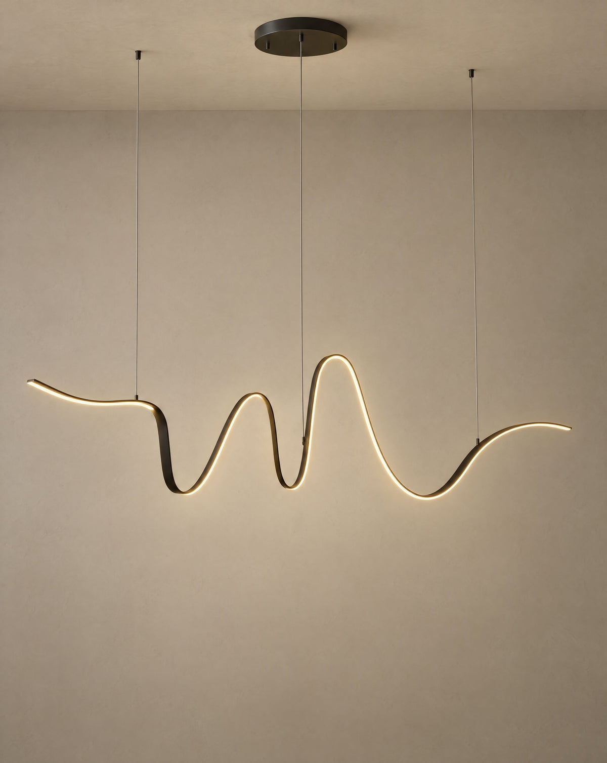 Solsence Lyra linear pendant light lit with warm 3000K glow on a greige wall