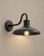 SCI Lighting Granger outdoor wall light lit with warm 3000K glow on a greige wall