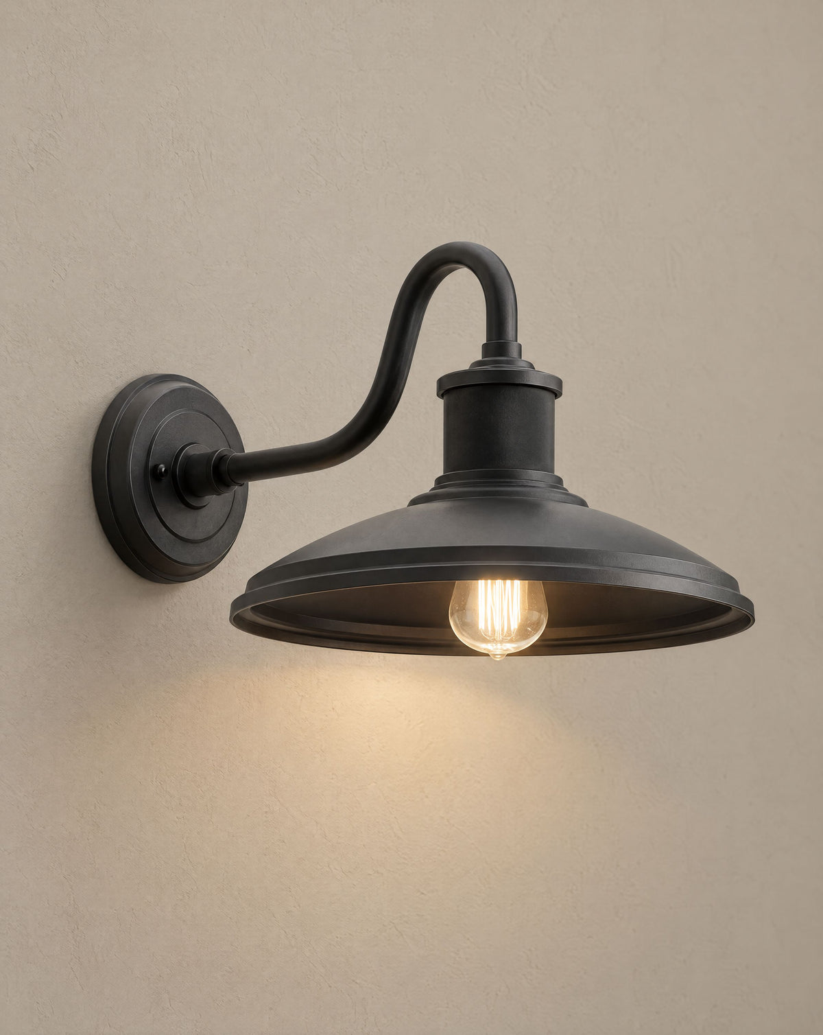 Solsence Granger outdoor wall light lit with warm 3000K glow on a greige wall