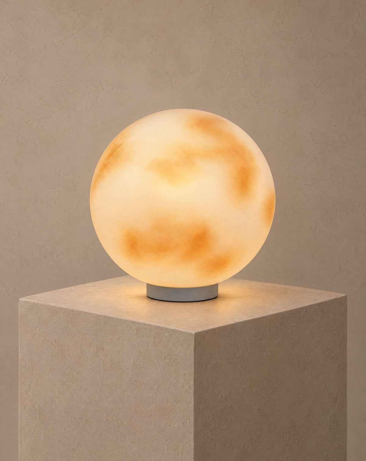 Solsence Selene moon pillar light lit with warm 3000K glow on a greige wall