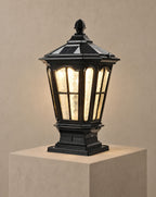 Solsence Pagoda black solar pillar light lit with warm 3000K glow on a greige wall