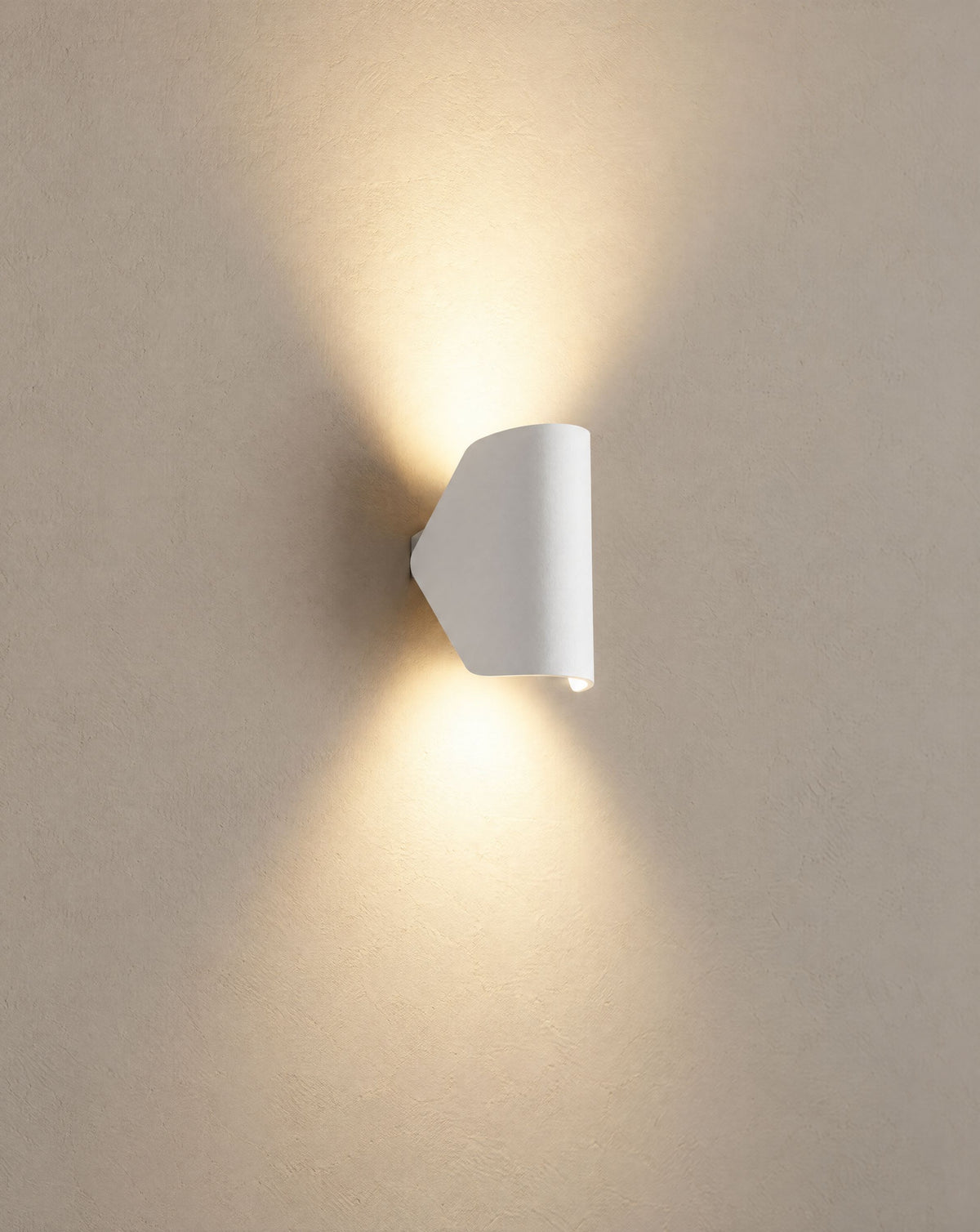 Solsence Pivot outdoor wall light - White lit with warm 3000K glow on a greige wall