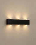 Solsence Duet up down outdoor wall light lit with warm 3000K glow on a greige wall
