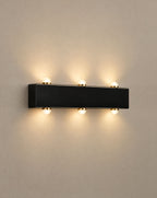 Solsence Duet up down outdoor wall light lit with warm 3000K glow on a greige wall