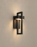 SCI Lighting Vesper outdoor wall sconce lit with warm 3000K glow on a greige wall