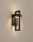 SCI Lighting Vesper outdoor wall sconce lit with warm 3000K glow on a greige wall