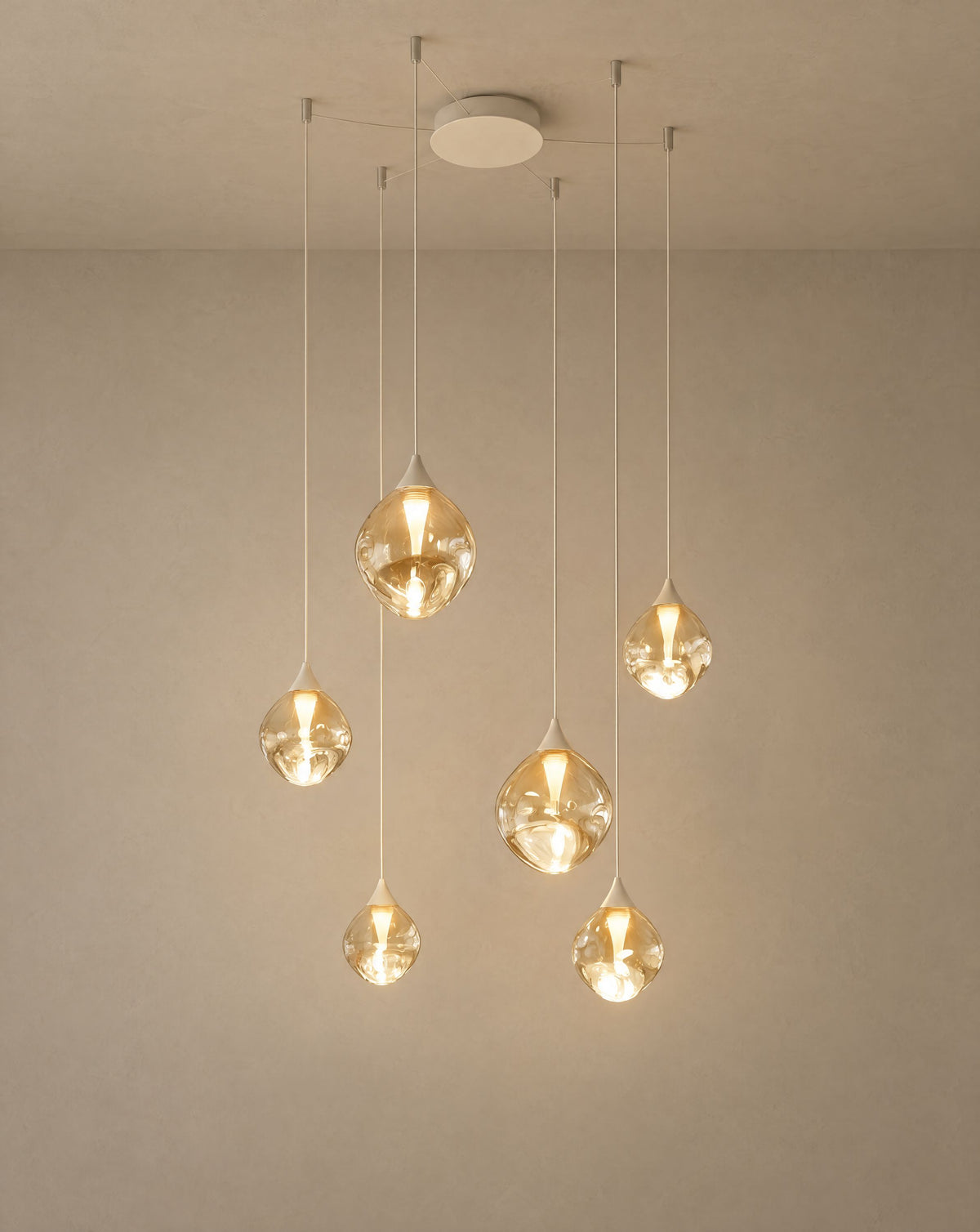 Solsence Cascade glass pendant light - White lit with warm 3000K glow on a greige wall