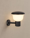 Solsence Chalice hardwired cup outdoor wall light lit with warm 3000K glow on a greige wall
