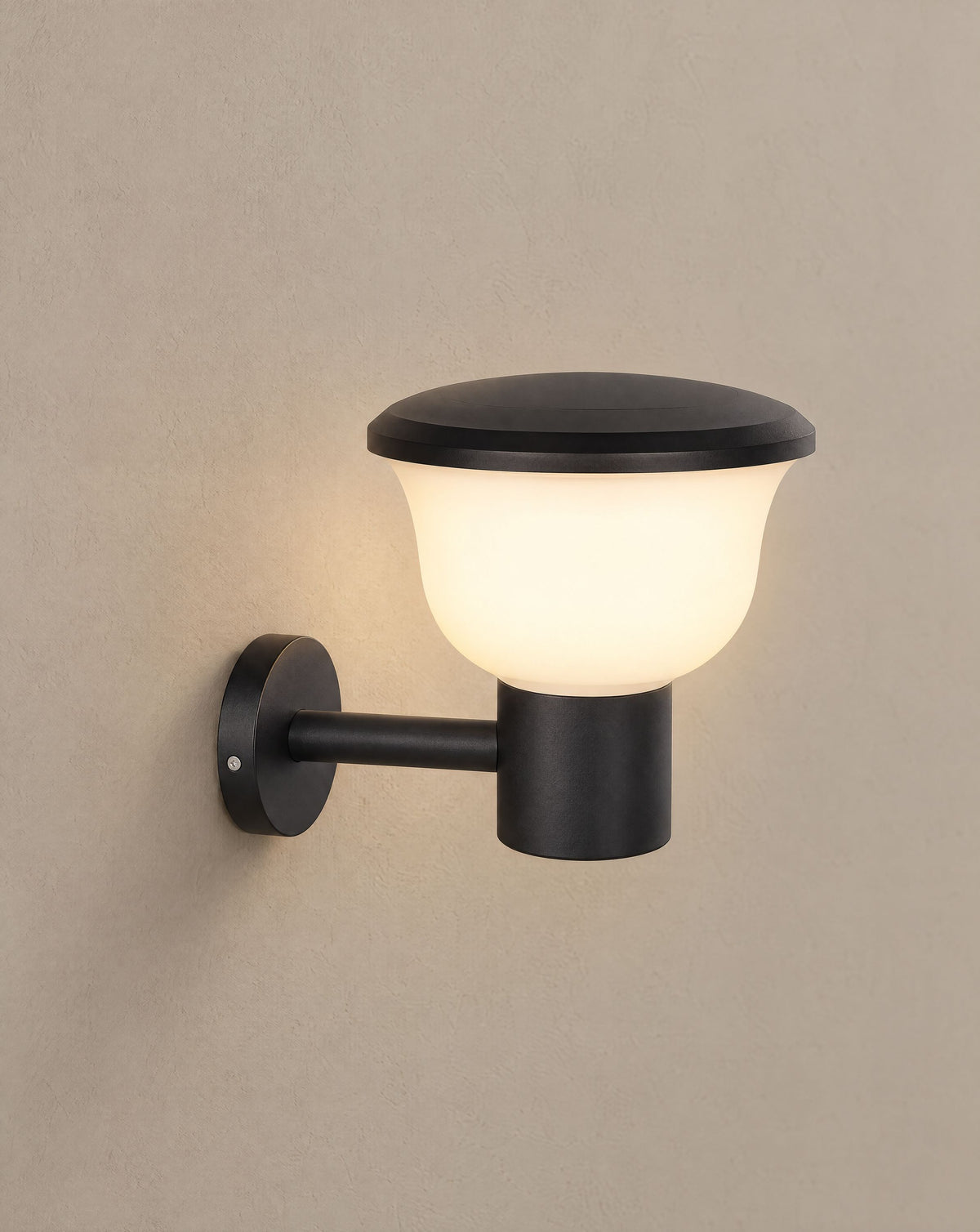 Solsence Chalice hardwired cup outdoor wall light lit with warm 3000K glow on a greige wall